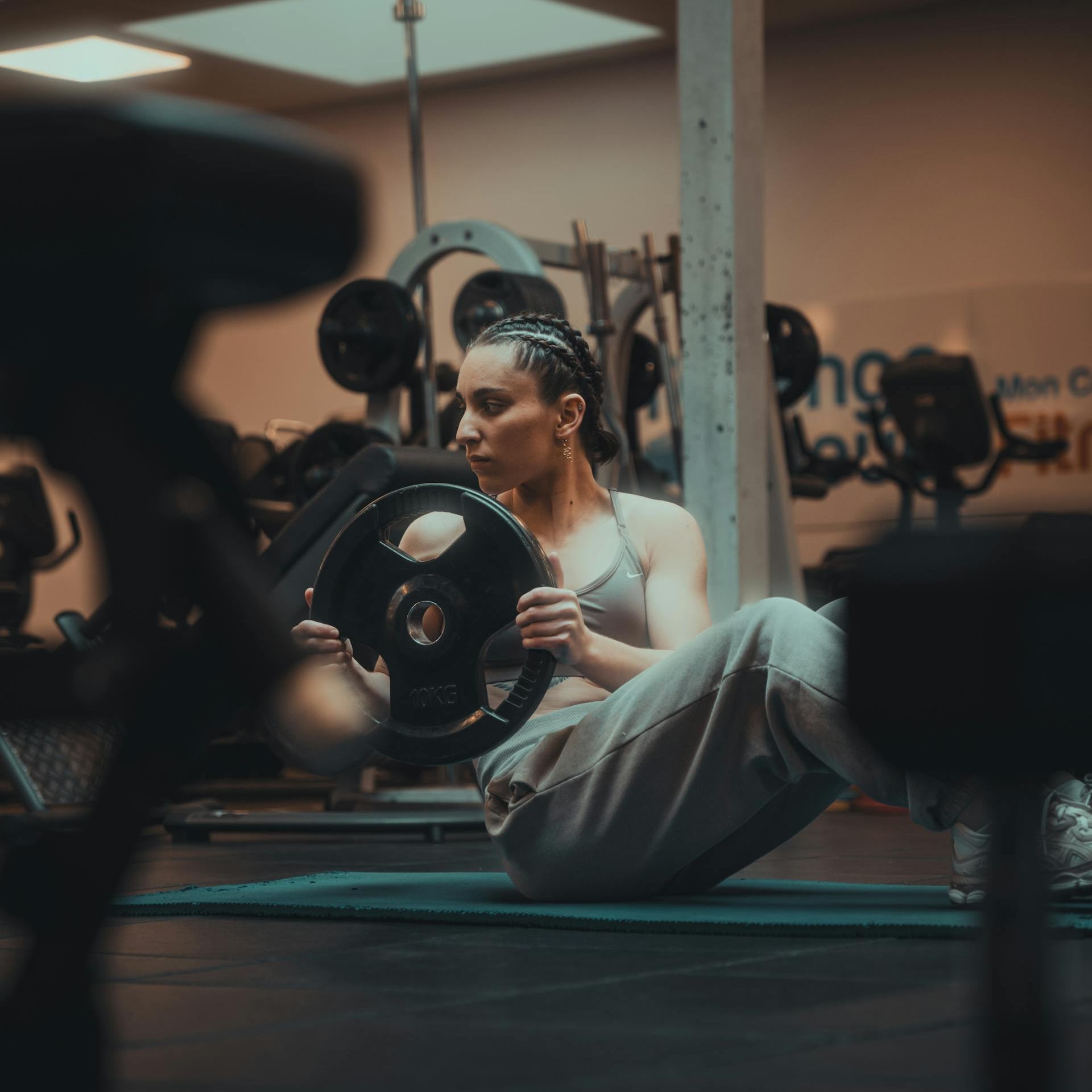 Woman exercising with weights in a gym setting